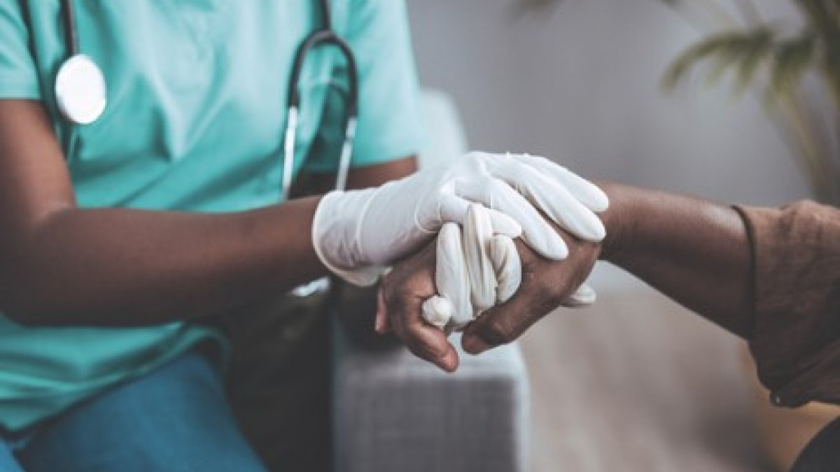 Doctor holding patient's hand