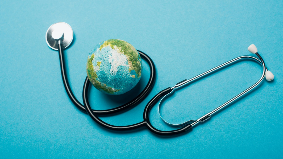 global health image - globe with stethoscope wrapped around
