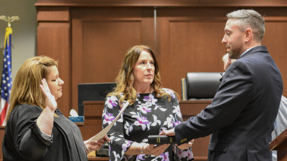 Zachary West, DO, FACOI being sworn in as coroner