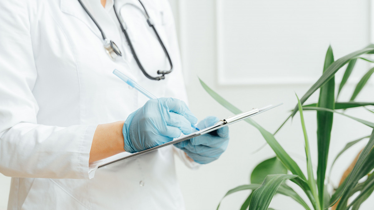 physician taking records to represent practice management
