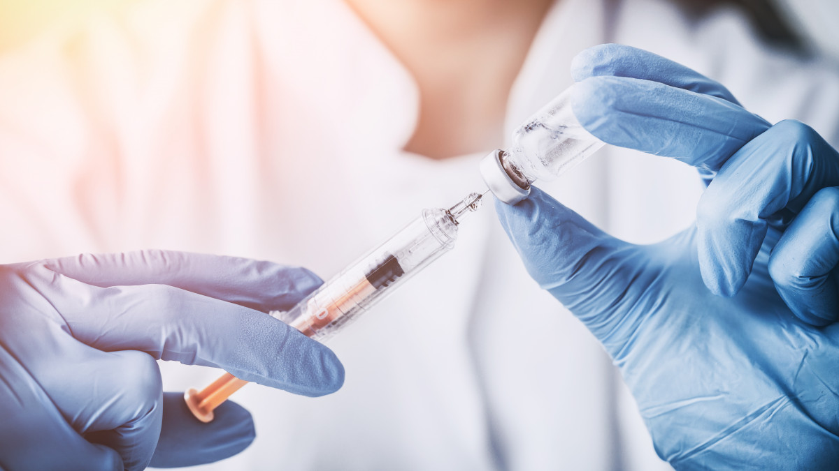 Doctor holding a syringe 