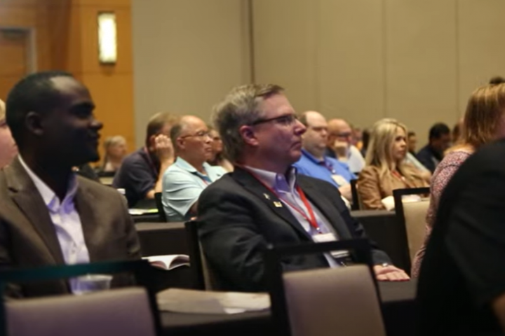 Members Watching a Lecture at an ACOI Conference